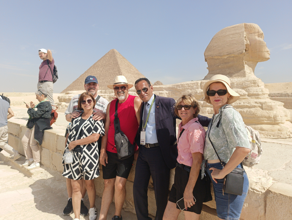 Khaled Abbass, professional Egyptologist and tour guide, leading a group in front of the Pyramids