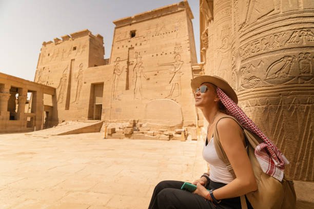 Woman sitting in Temple of Philae aka Temple of Isis in Aswan Egypt,Agilkia Island