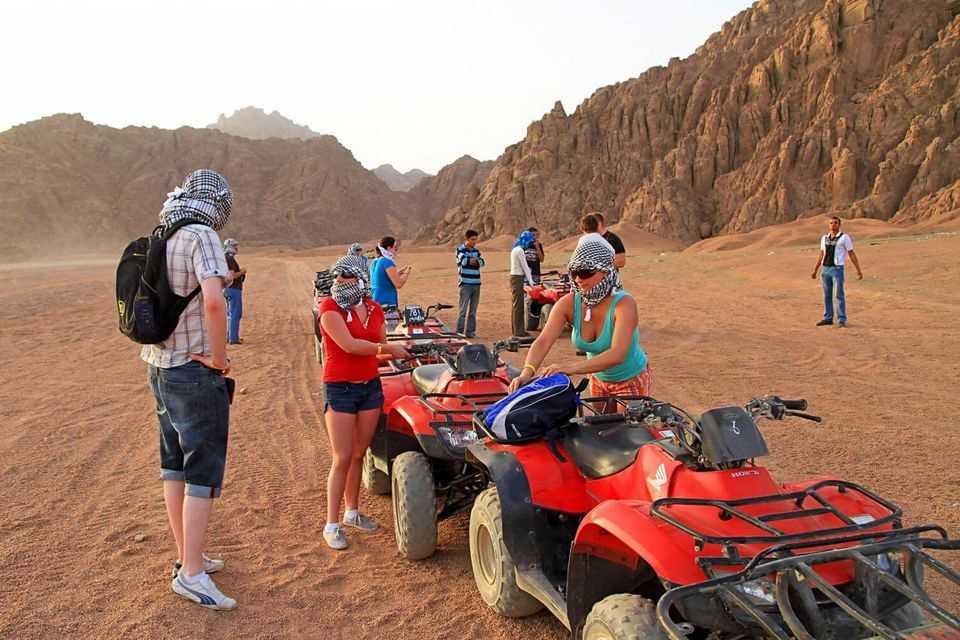 Tourists riding quad bikes during a super safari desert adventure in Hurghada, Egypt